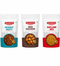 Three stand-up pouches of Zelawati brand pet chow products on a white background: Peanut Tasty, Mini Kachori, and Ratlami Sev.